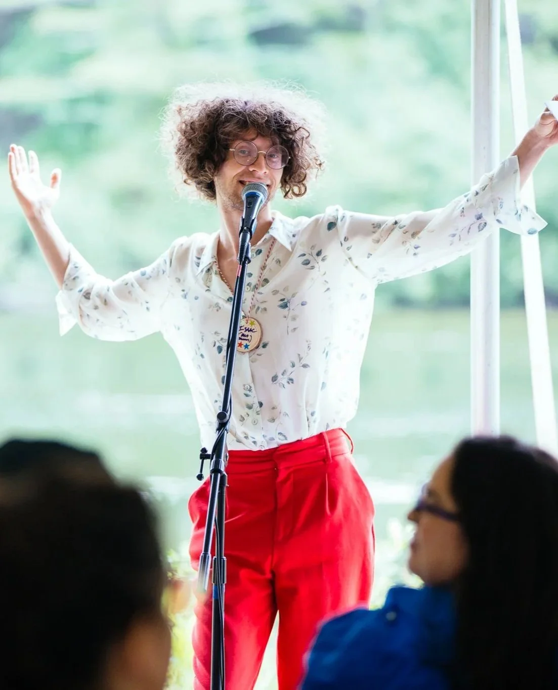 Someone stands in front of a microphone and speaks to the crowd