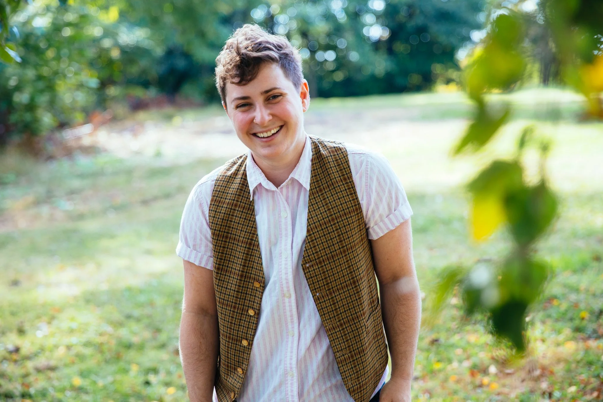 A photo of Batya standing and smiling outside