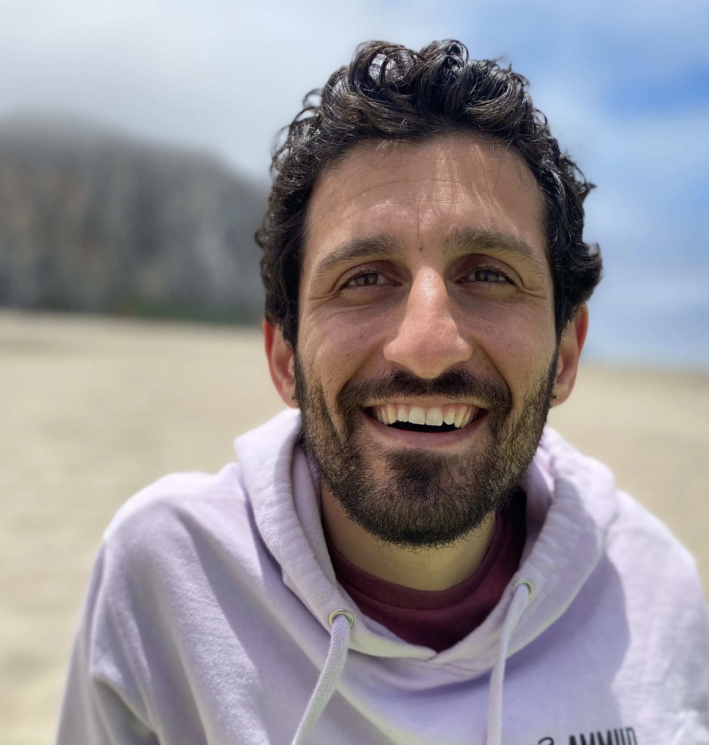 A photo of Nadav smiling at the camera