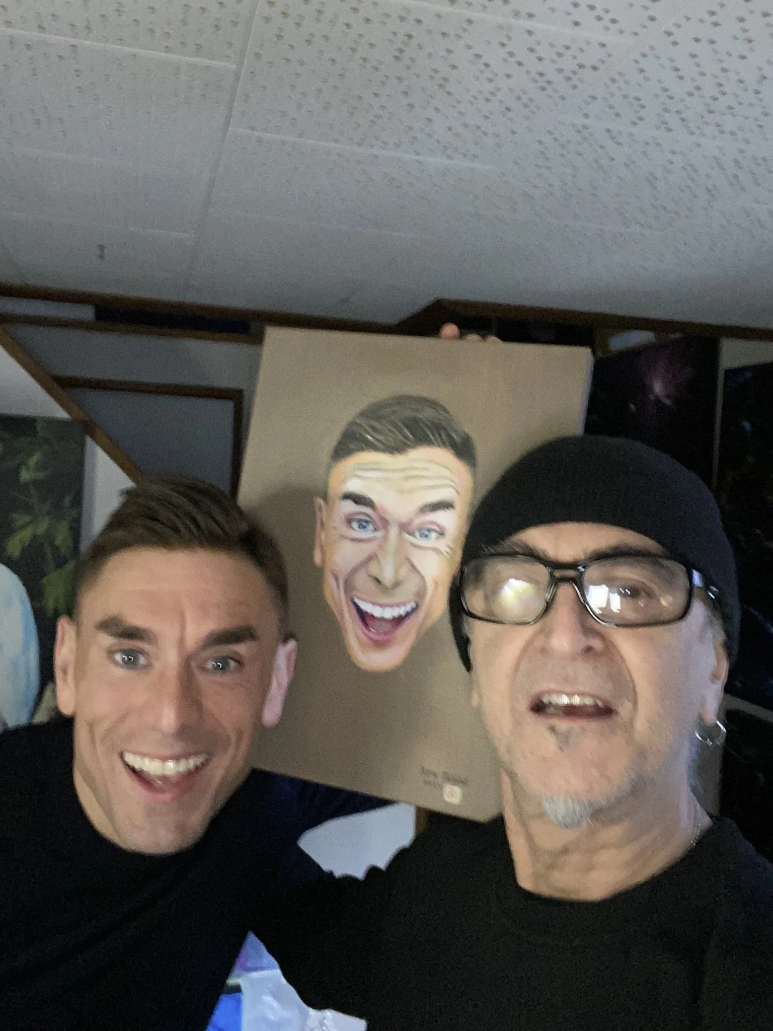 Ken with comedian James Mullinger with portrait painted by Ken.