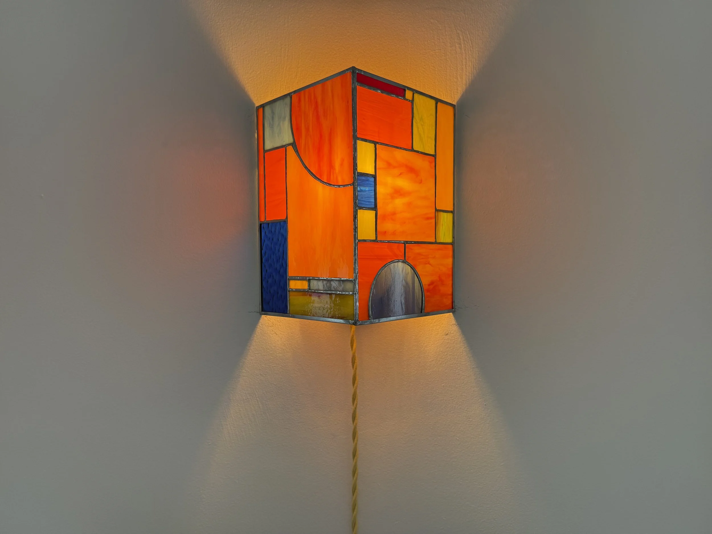 Max's Sconce, 2025, glass, light bulb, cord and plug, wall-mounted light fixture, solder, zinc came, 10" x 6" x 11.5"