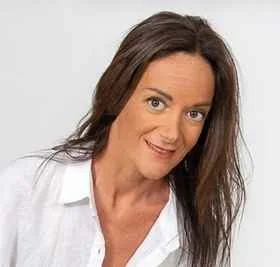 Brunette woman in white collared shirt smiling