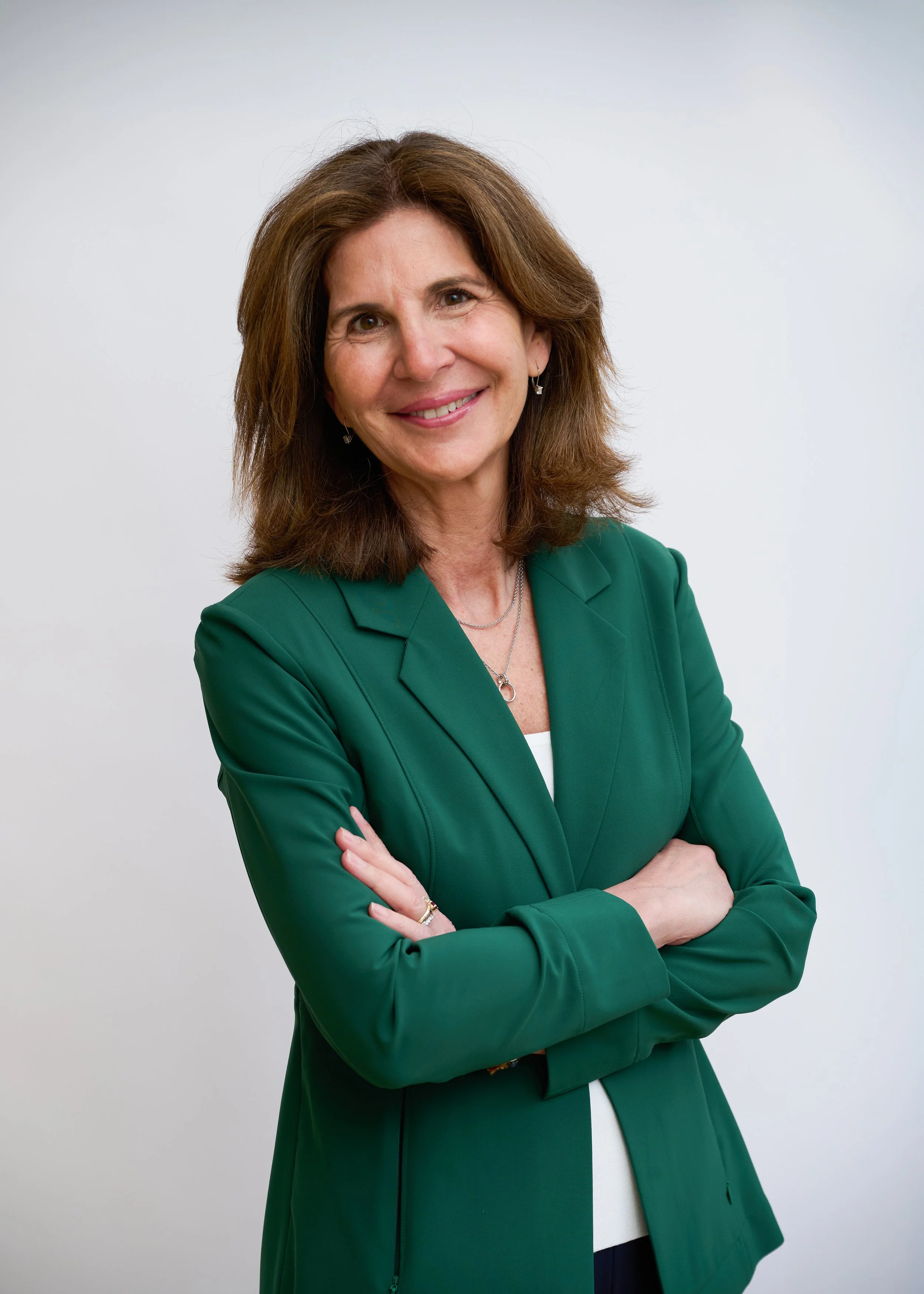 Bio photo of Stephanie Georges wearing green blazer