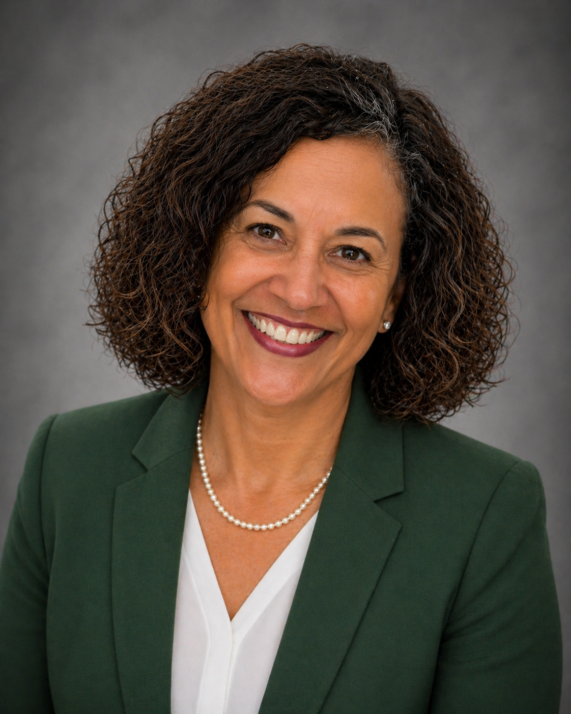 Kelly Price Noble Headshot with Green Suit