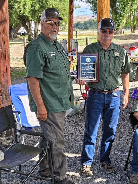 One ISSAR member presenting the Cole Colvin 50-Year Service Award to another ISSAR member.
