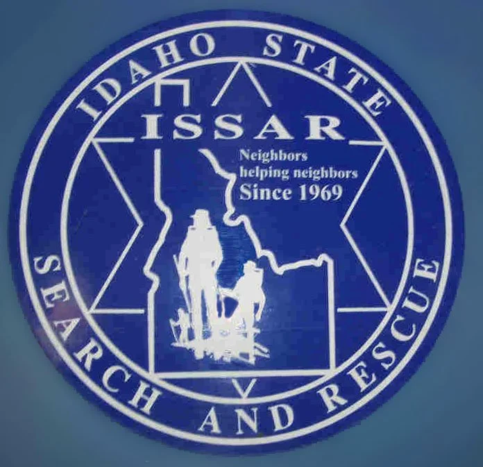 Seal of the Idaho State Search and Rescue (ISSAR) featuring the outline of Idaho with a hiker and dog, and text indicating ISSAR's mission and history since 1969.