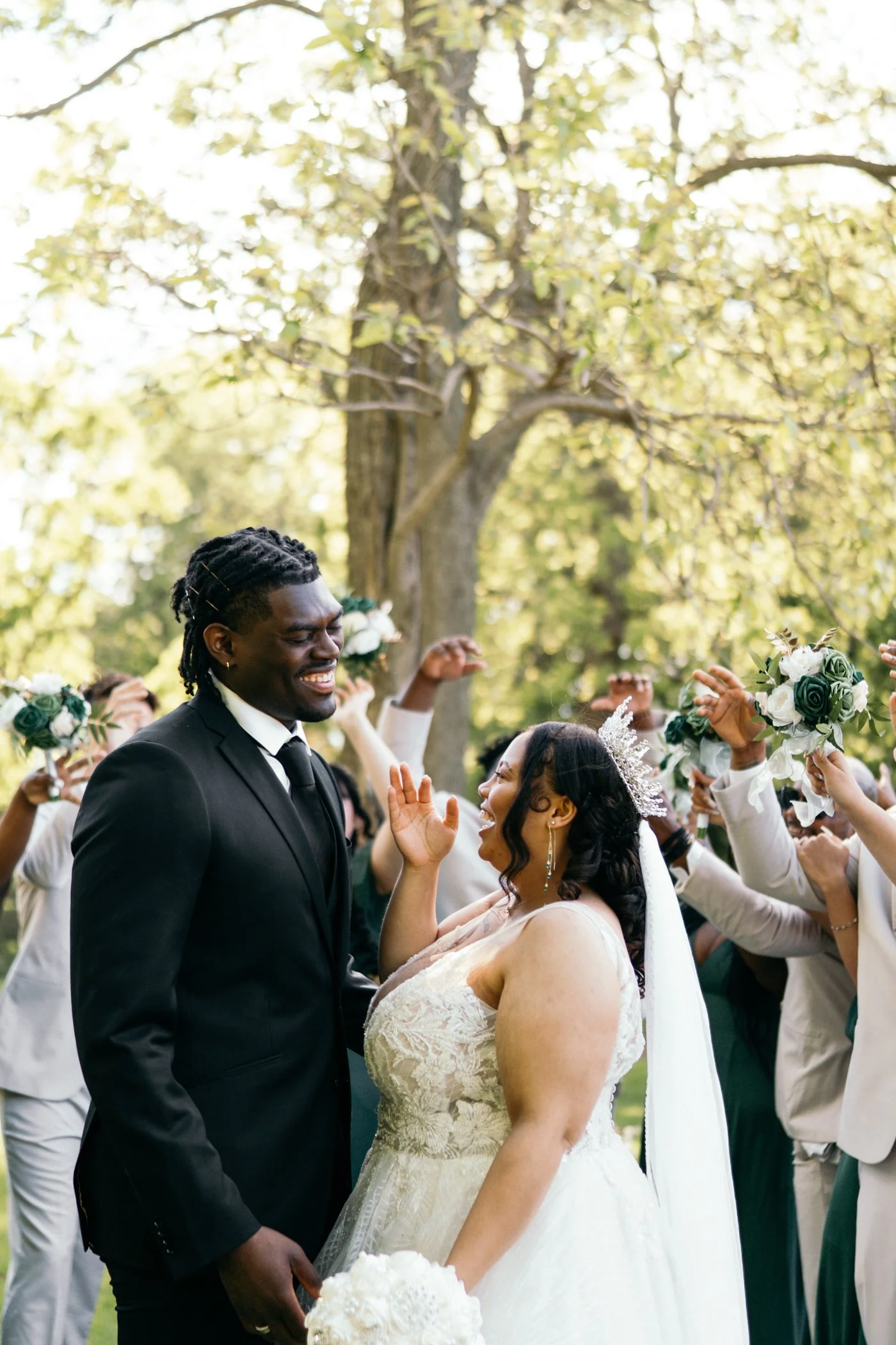 Bride and groom enjoying their wedding in an outdoor setting with friends celebrating around them. Madison, WI wedding photographer, Jevon Photo.