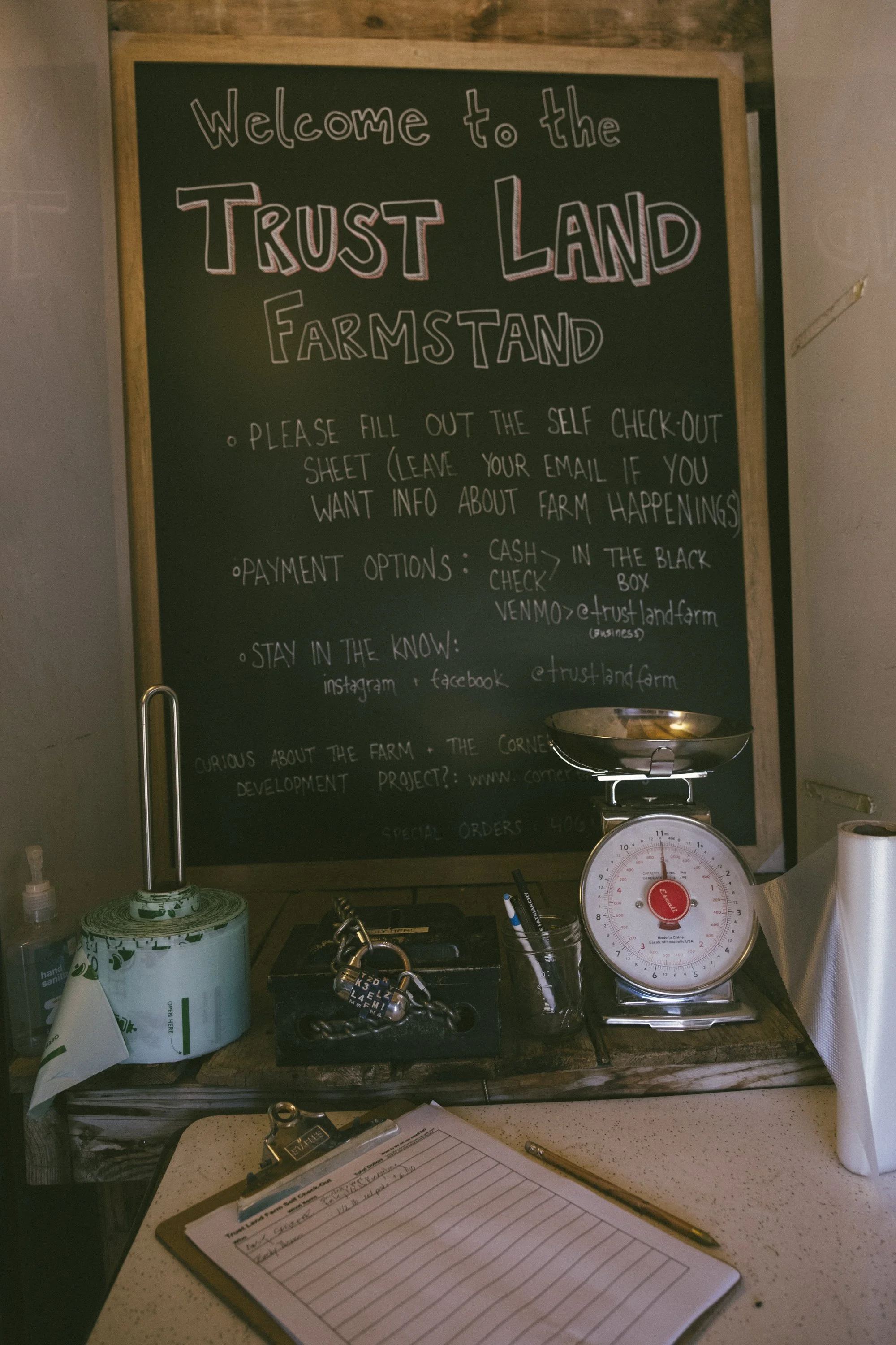 A chalkboard with instructions on how to shop their self-serve farm stand