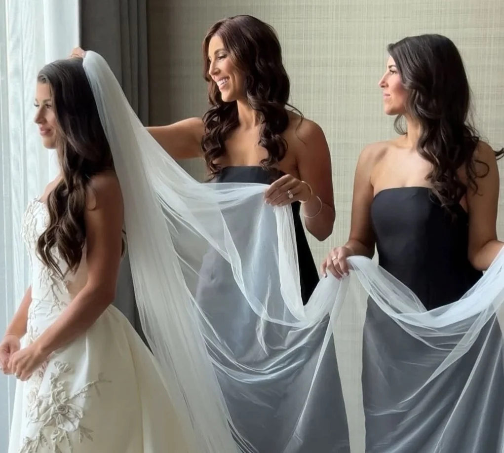 Close-up of bride’s radiant caramel spray tan glow in lace wedding gown.