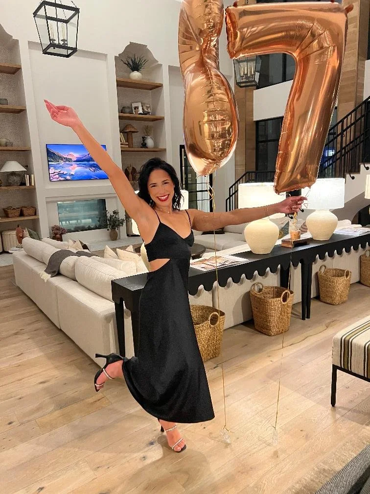 Woman posing sideways to show side caramel tan glow for her birthday tan.