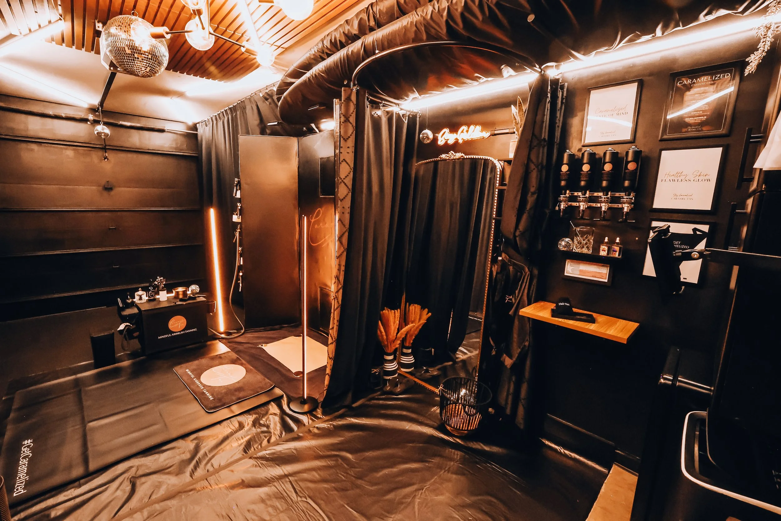 Full view of the Caramel Tan Wellness Studio showing the private treatment area, grounding mat setup, and calm, minimalist decor.