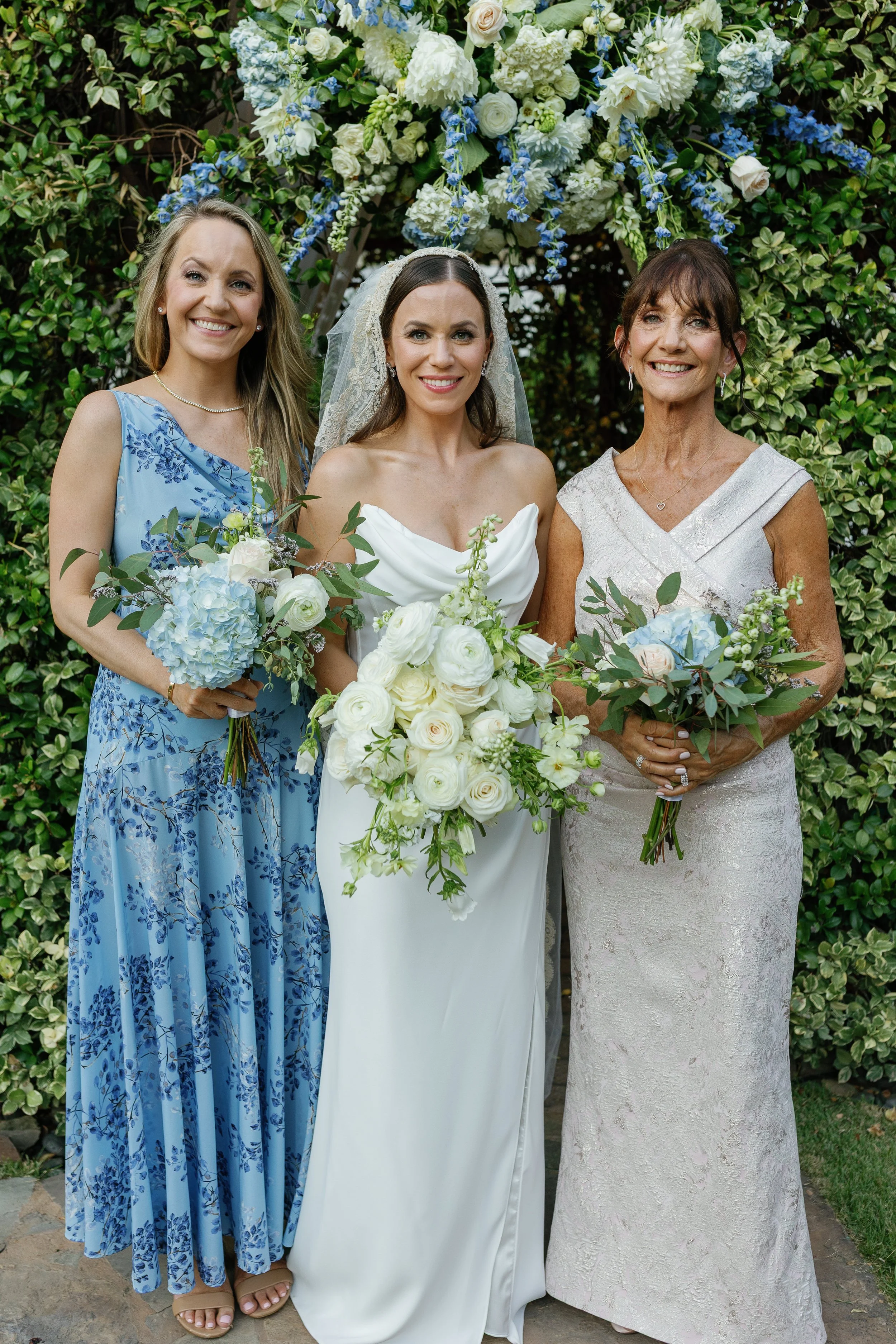 Bridal party photo featuring the bride, her bridesmaids, and her mom after receiving Caramel Tan’s wedding spray tan services.