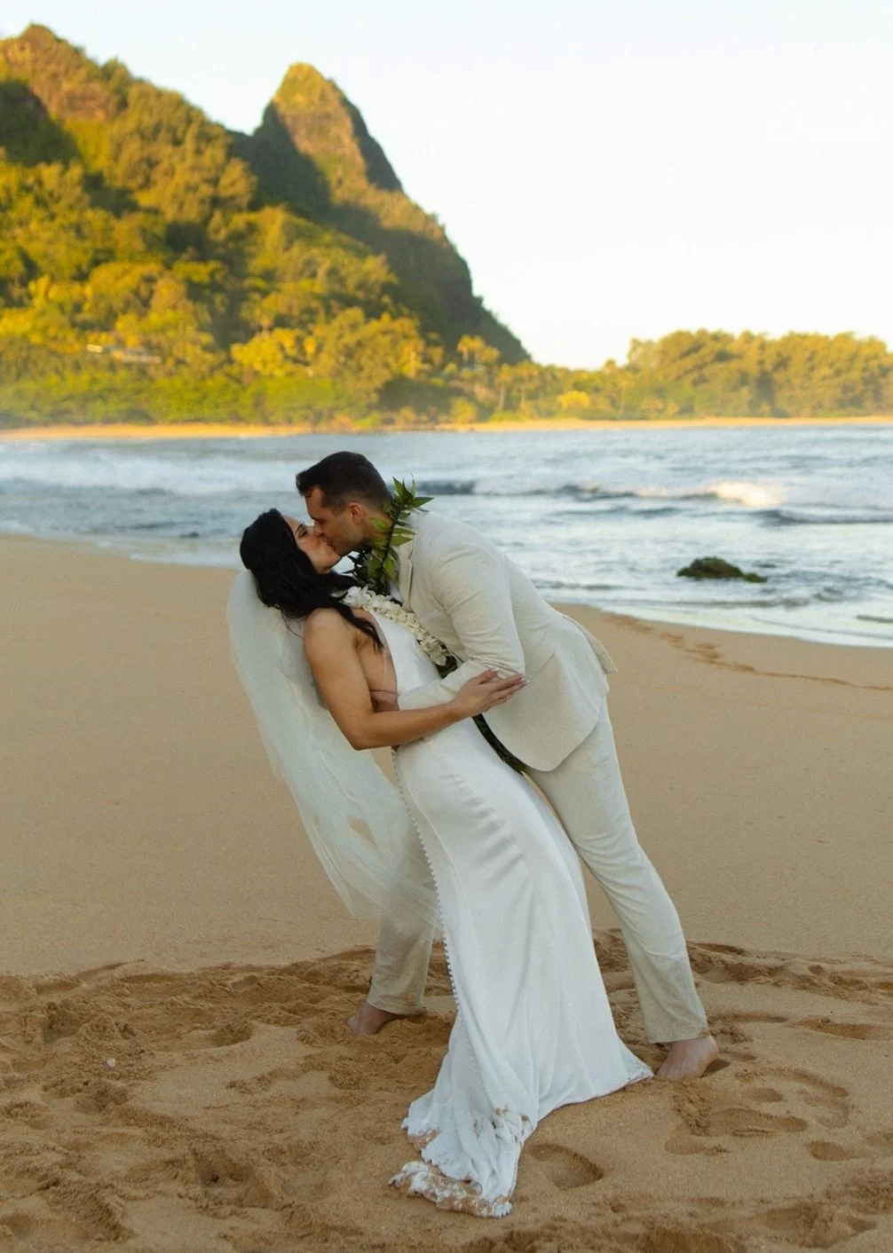 Custom Caramelized spray tan for bride in backless gown showcasing even, radiant glow.