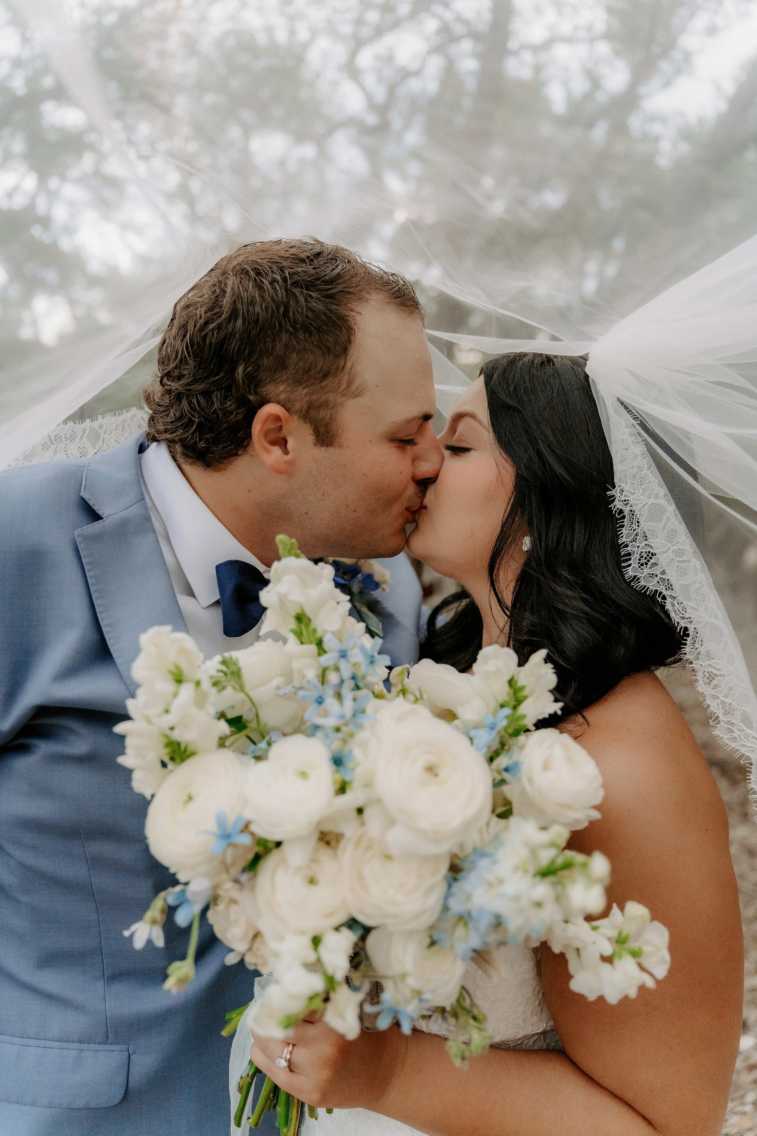 Luxury Austin bridal spray tan on bride in flowing dress with veil during golden hour portraits.