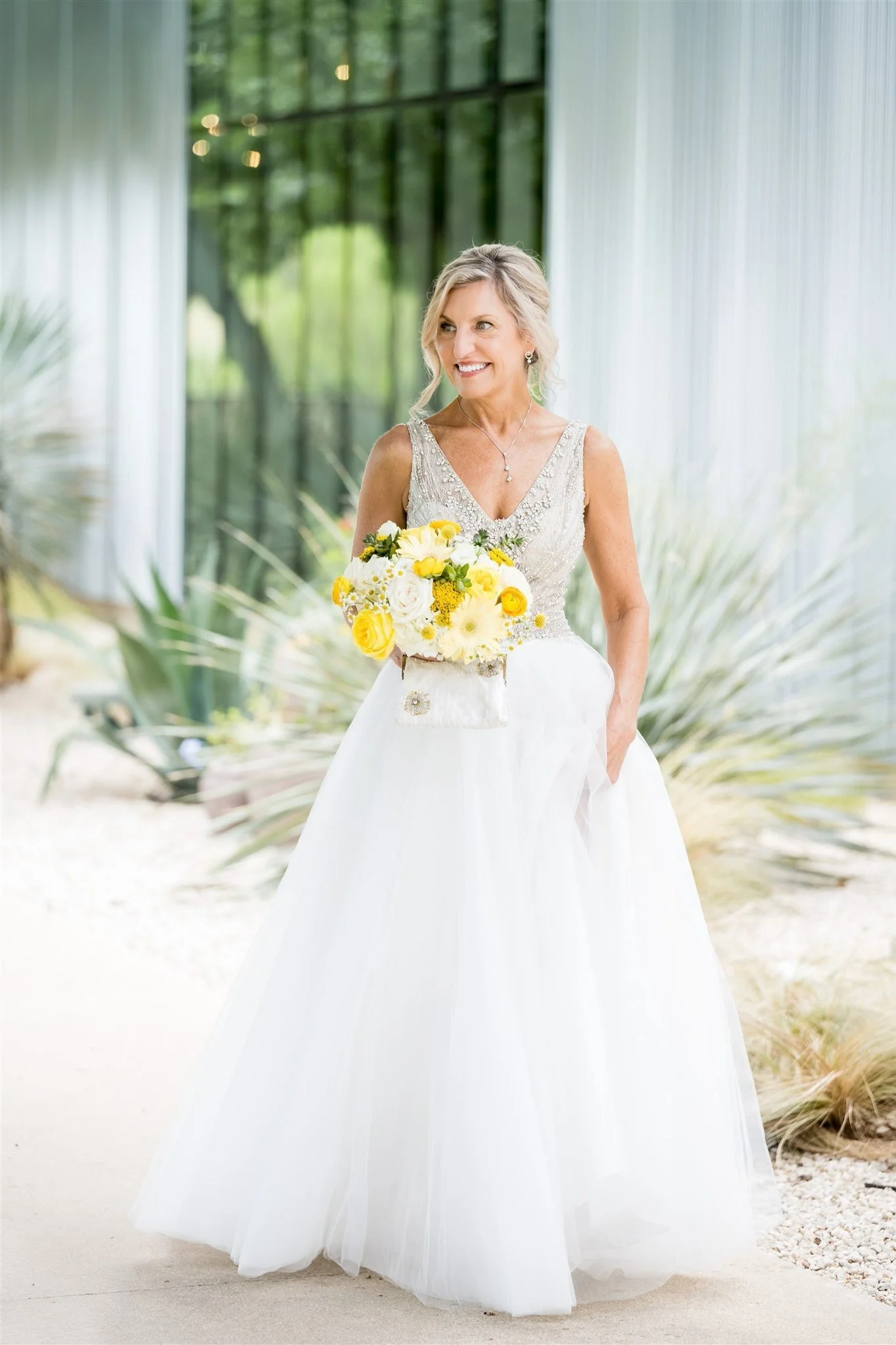 Austin bride glowing with natural Caramel Tan spray tan in a white lace gown on her wedding morning.