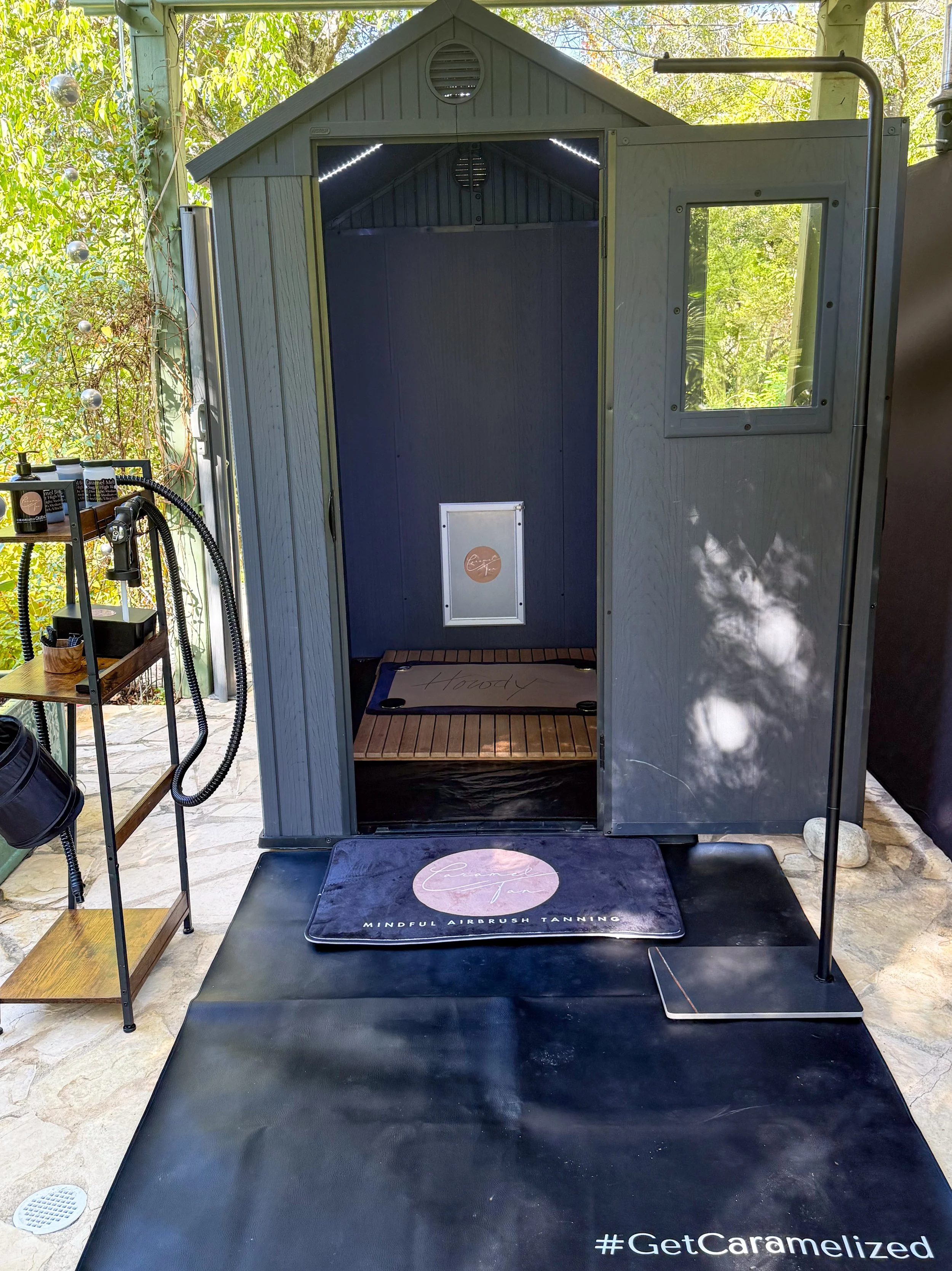 Open-air spray tan area at the Caramel Tan Garden Studio in West Lake Hills, surrounded by natural light and fresh Austin air.