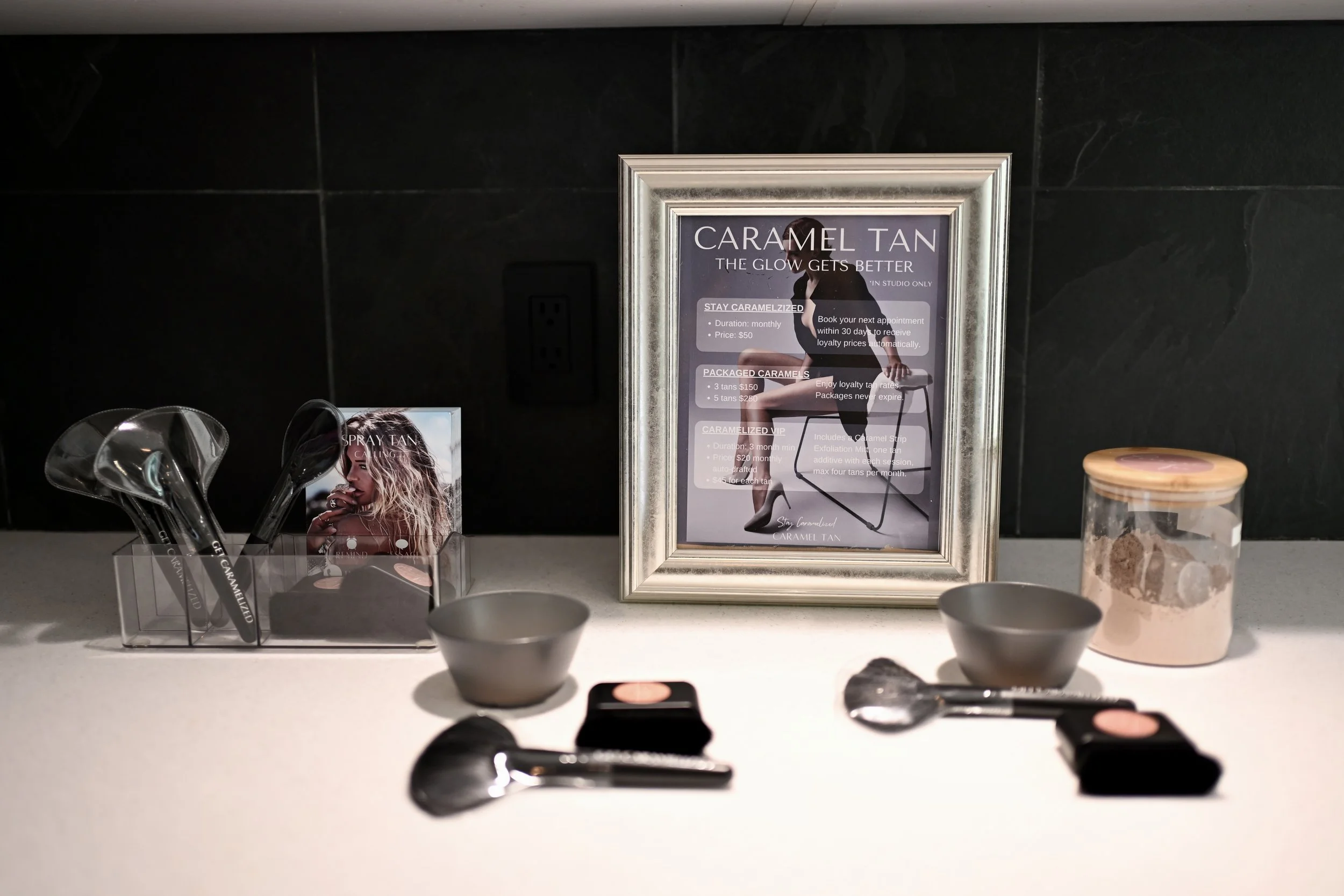 Open-air spray tan setup at the Caramel Tan Garden Studio in West Lake Hills, featuring the clean, organized station used for custom airbrush tanning.