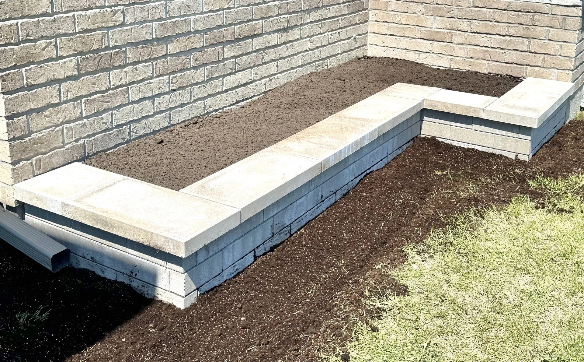 Front yard landscaping with stone garden bed border at Ottawa home