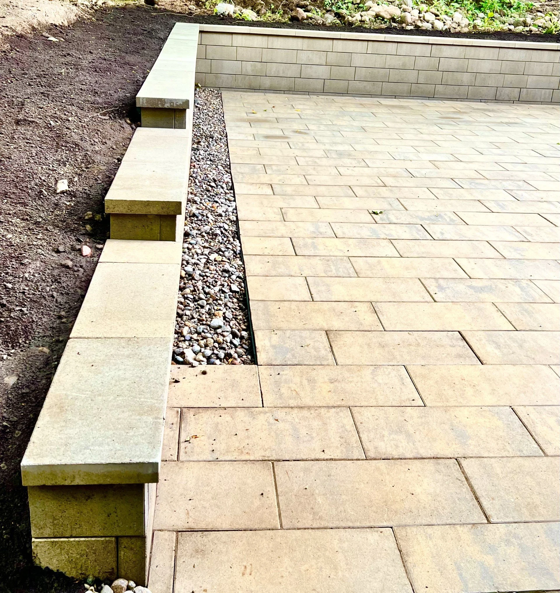 Beige interlock patio with stone border and clean finish in Ottawa