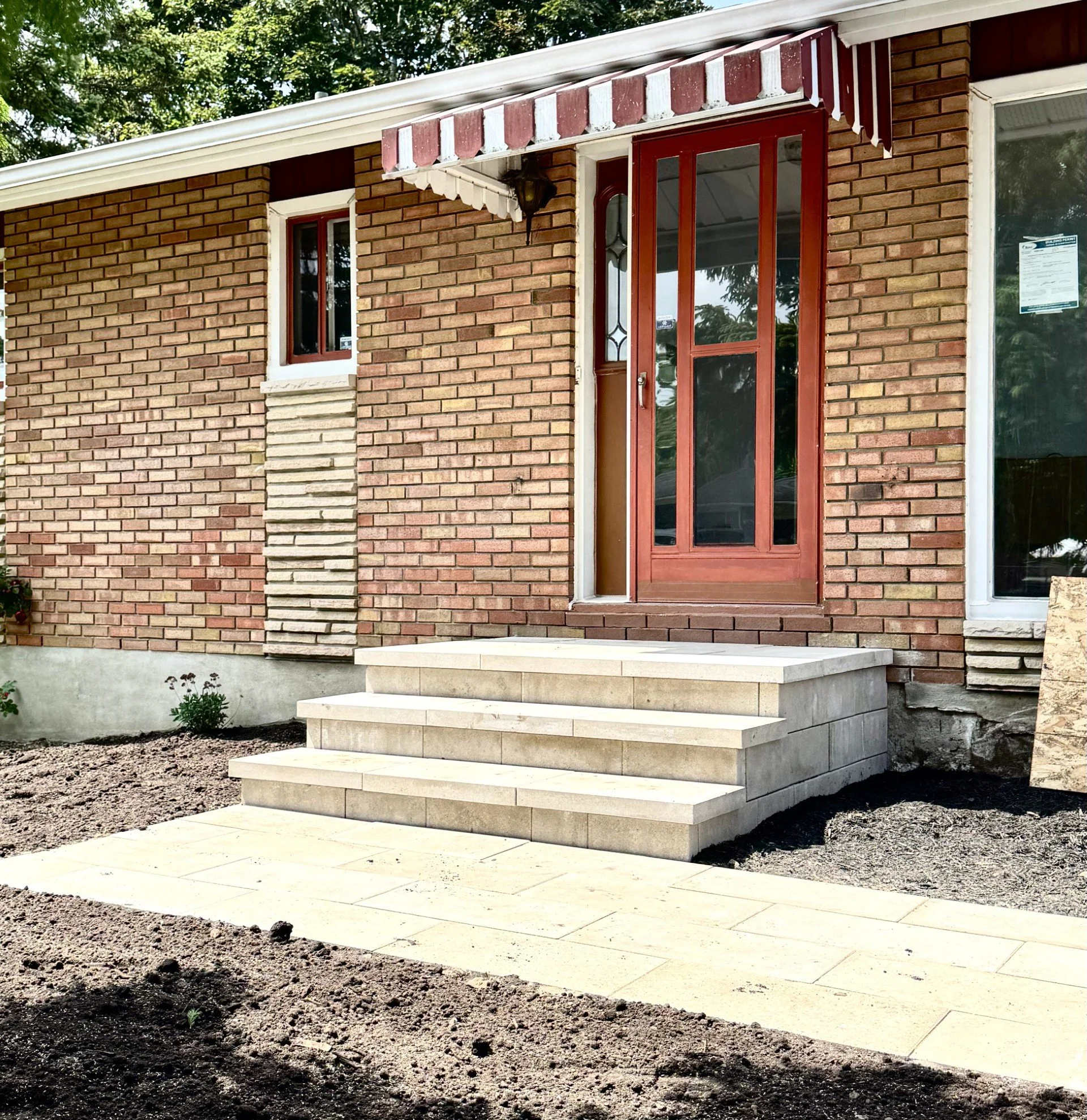 Front entrance with stone steps and interlock walkway in Ottawa