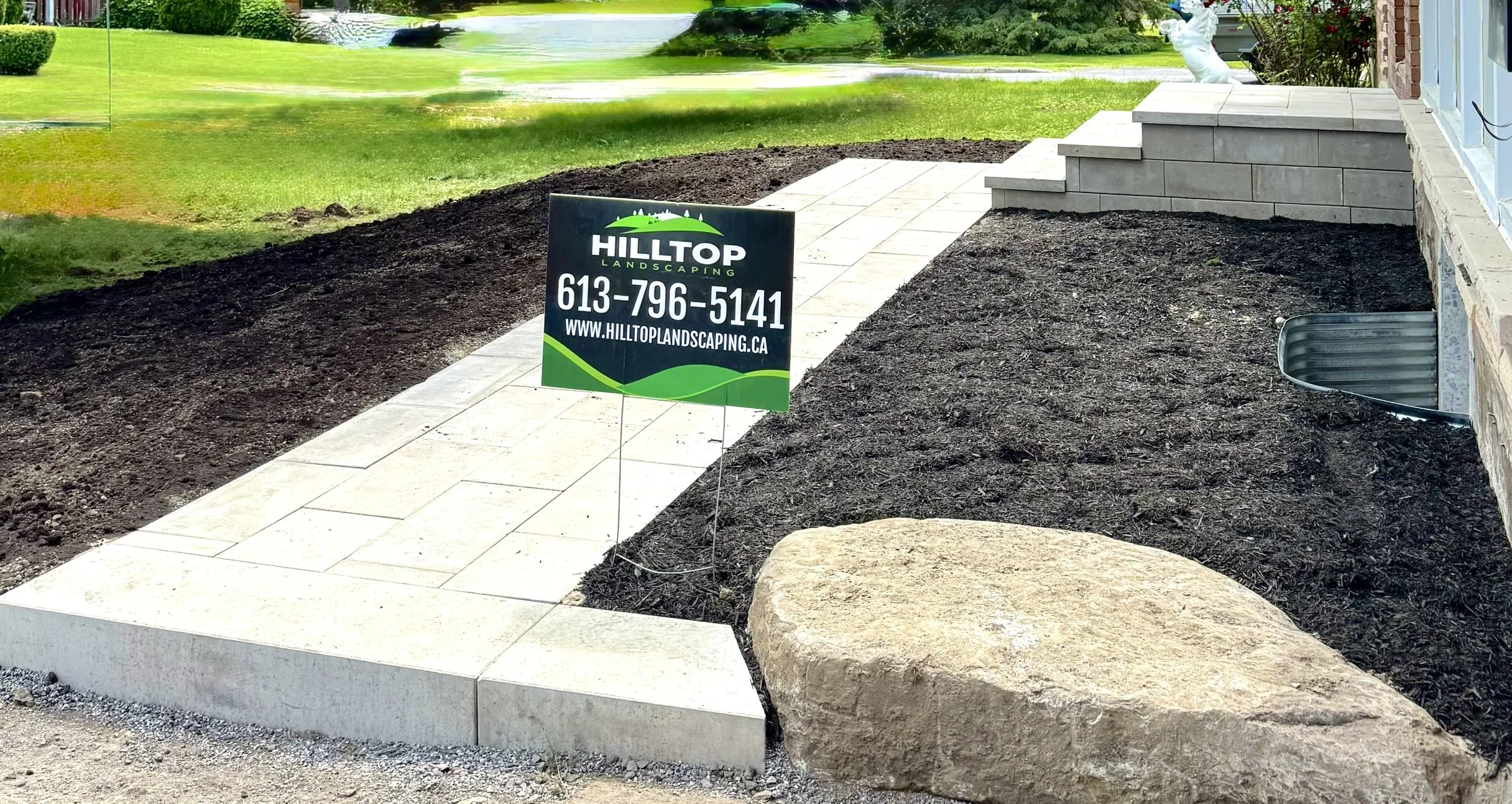 Frontyard landscaping with interlock patio and stone step detail in Ottawa