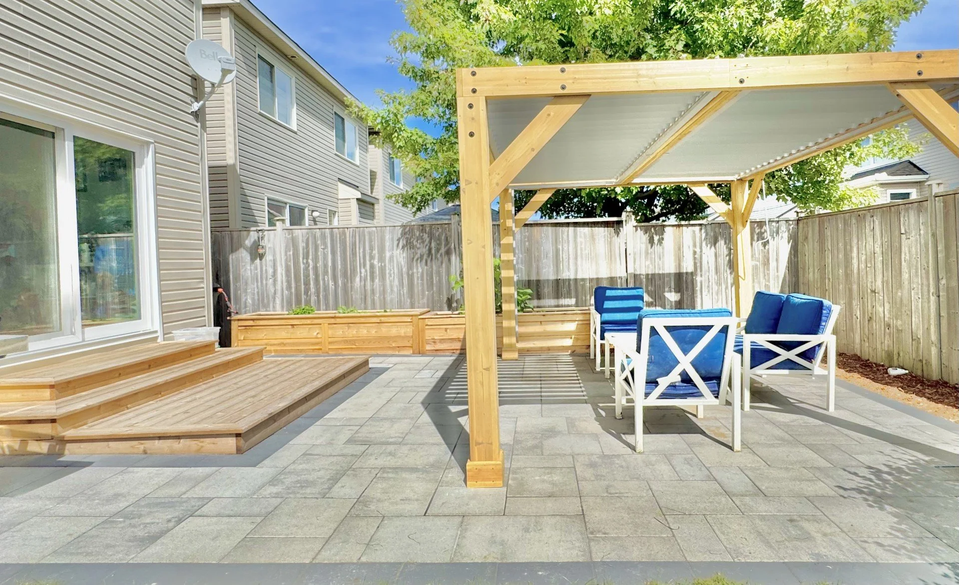 Interlock patio with pergola and outdoor living space in Ottawa backyard