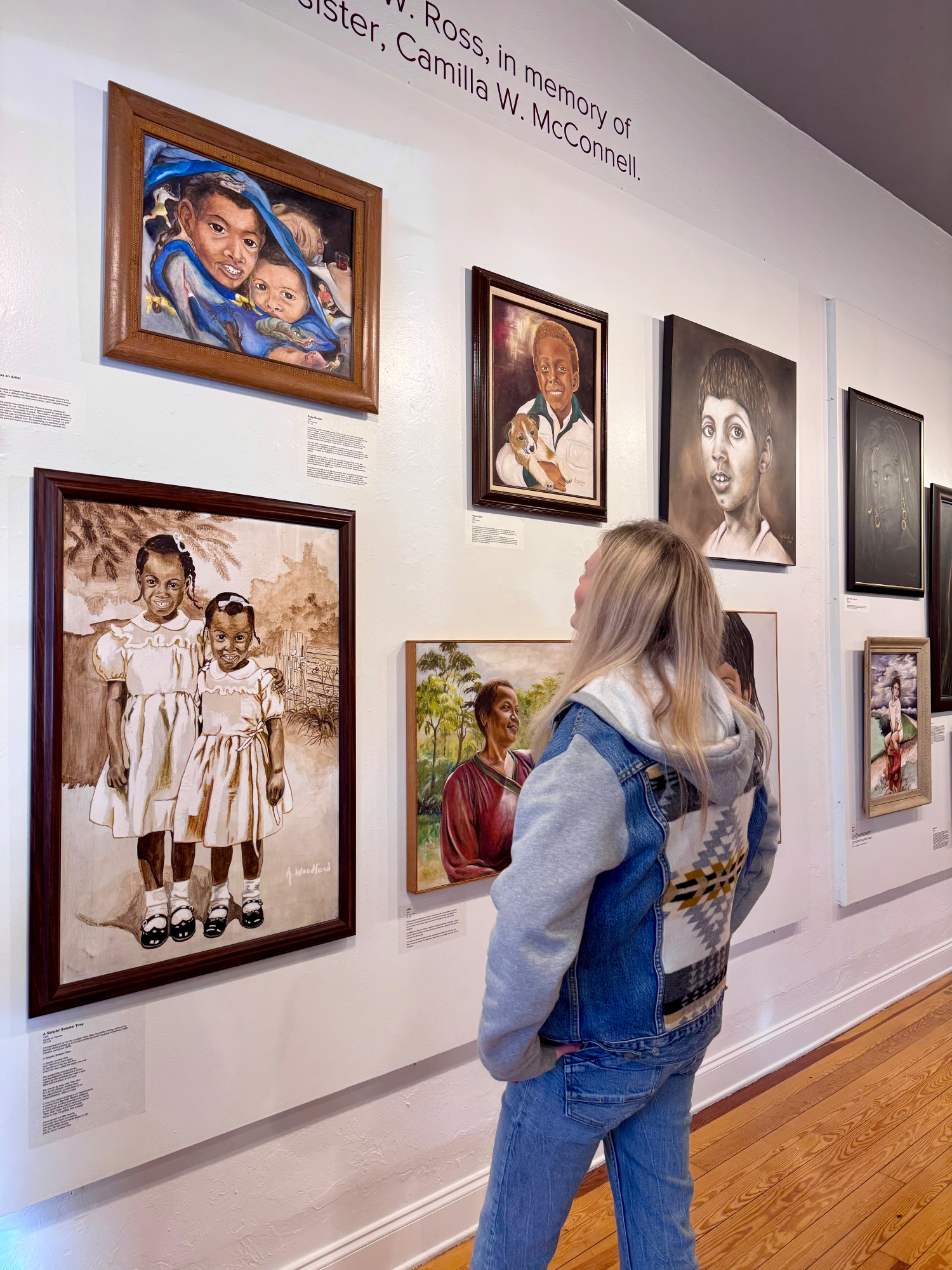 Sabine looking at art on the wall at the gallery