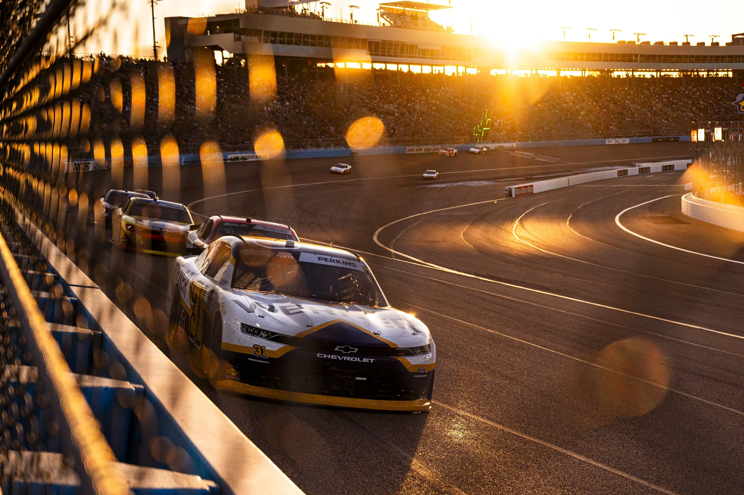 No. 31 Jordan Anderson Racing Chevrolet driven by Blaine Perkins racing at Phoenix Raceway, O'Reilly Auto Parts Series sunset golden hour