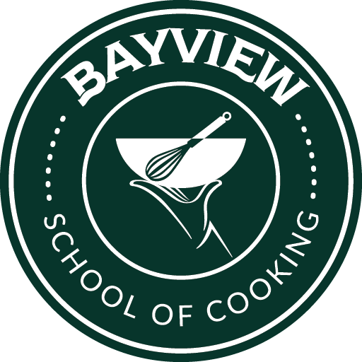 Logo for Bayview School of Cooking, featuring a whisk and bowl with a hand holding a spoon.