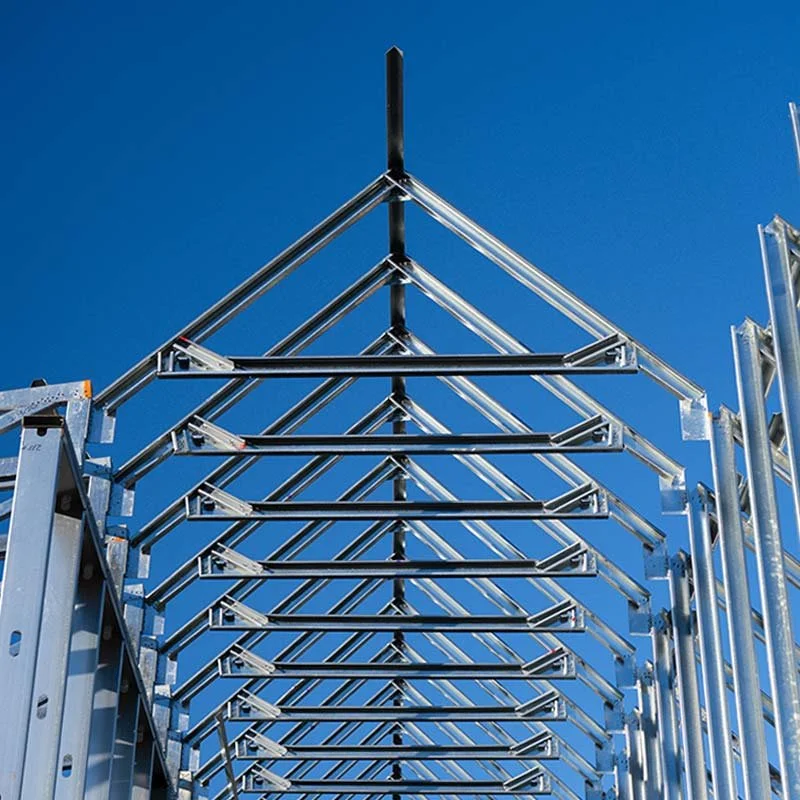 Metal framework structure on building site against blue sky