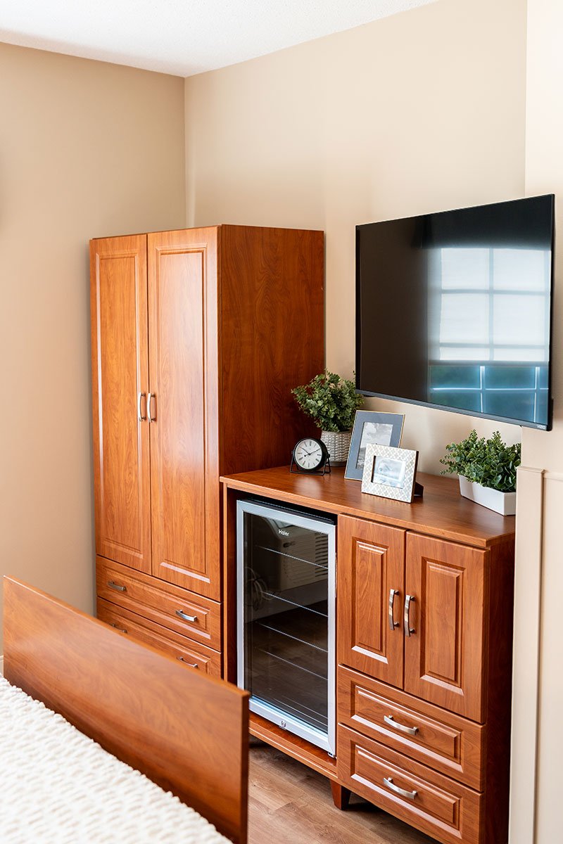 Wide view of a renovated resident room at Hendersonville Health & Rehabilitation with tv and storage