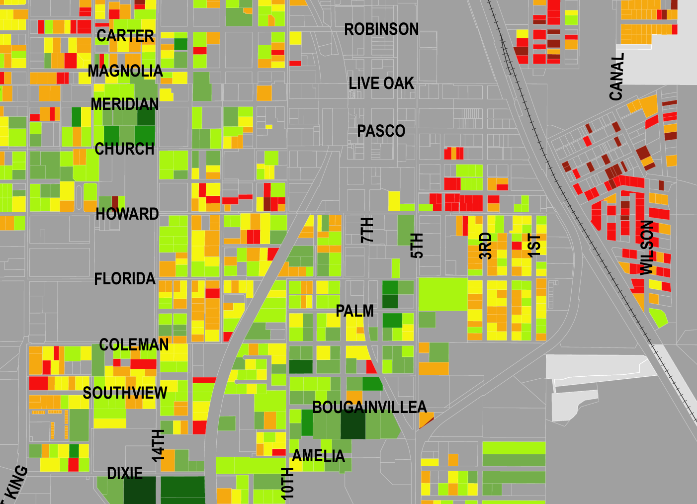 A detailed map showing a neighborhood with streets labeled, including Carter, Magnolia, Meridian, Church, Howard, Florida, Coleman, Southview, Dixie, 14th, 10th, Palm, Bougainvillea, 1st, 3rd, 5th, 7th, Robbins, Live Oak, Pasco, Wilson, and Canal. The map highlights areas with colored blocks in shades of green, yellow, orange, and red, indicating different data levels, over a gray background.