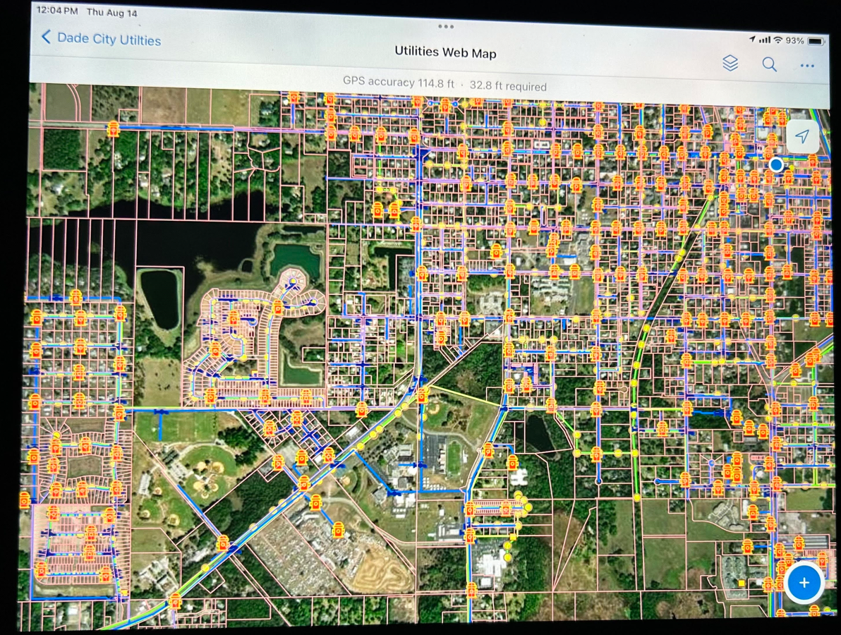 Map of Dade City utilities showing roads, water, and power lines with various utility markers and a large water body on the left side.