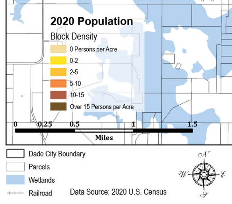 Map showing population density in 2020, with various colors representing different densities, along with boundaries, parcels, wetlands, and railroad lines in a city, based on 2020 U.S. Census data.