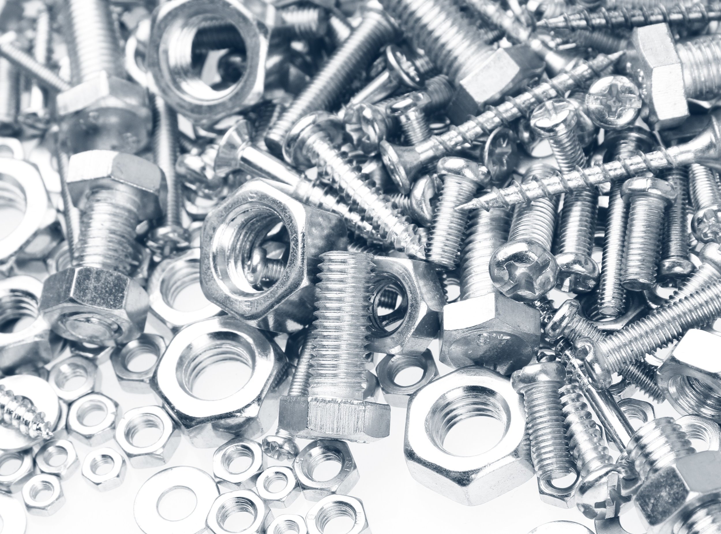 A collection of shiny metal screws, bolts, nuts, and washers.