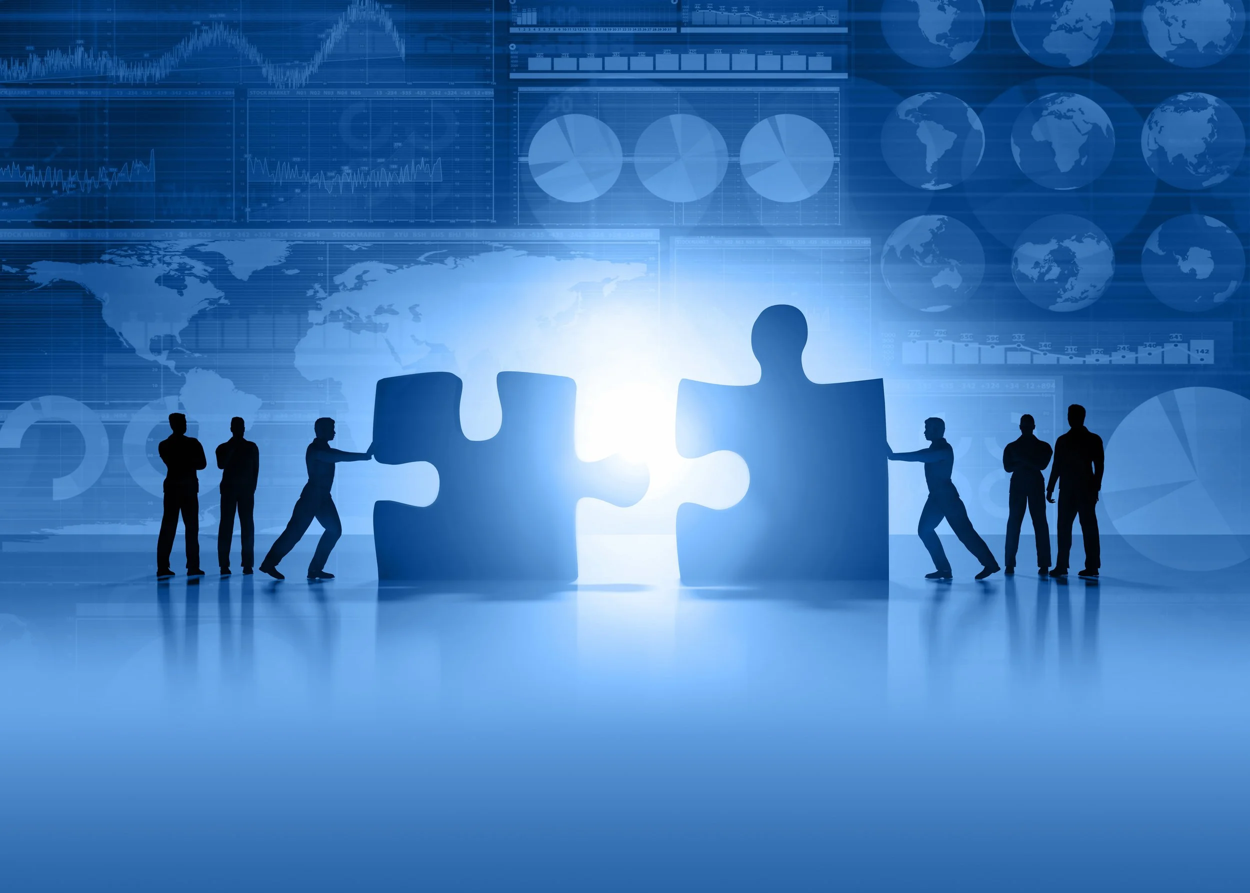 Silhouettes of businesspeople assembling a puzzle piece with digital graphs and world maps in the background, symbolizing global data analysis and teamwork.