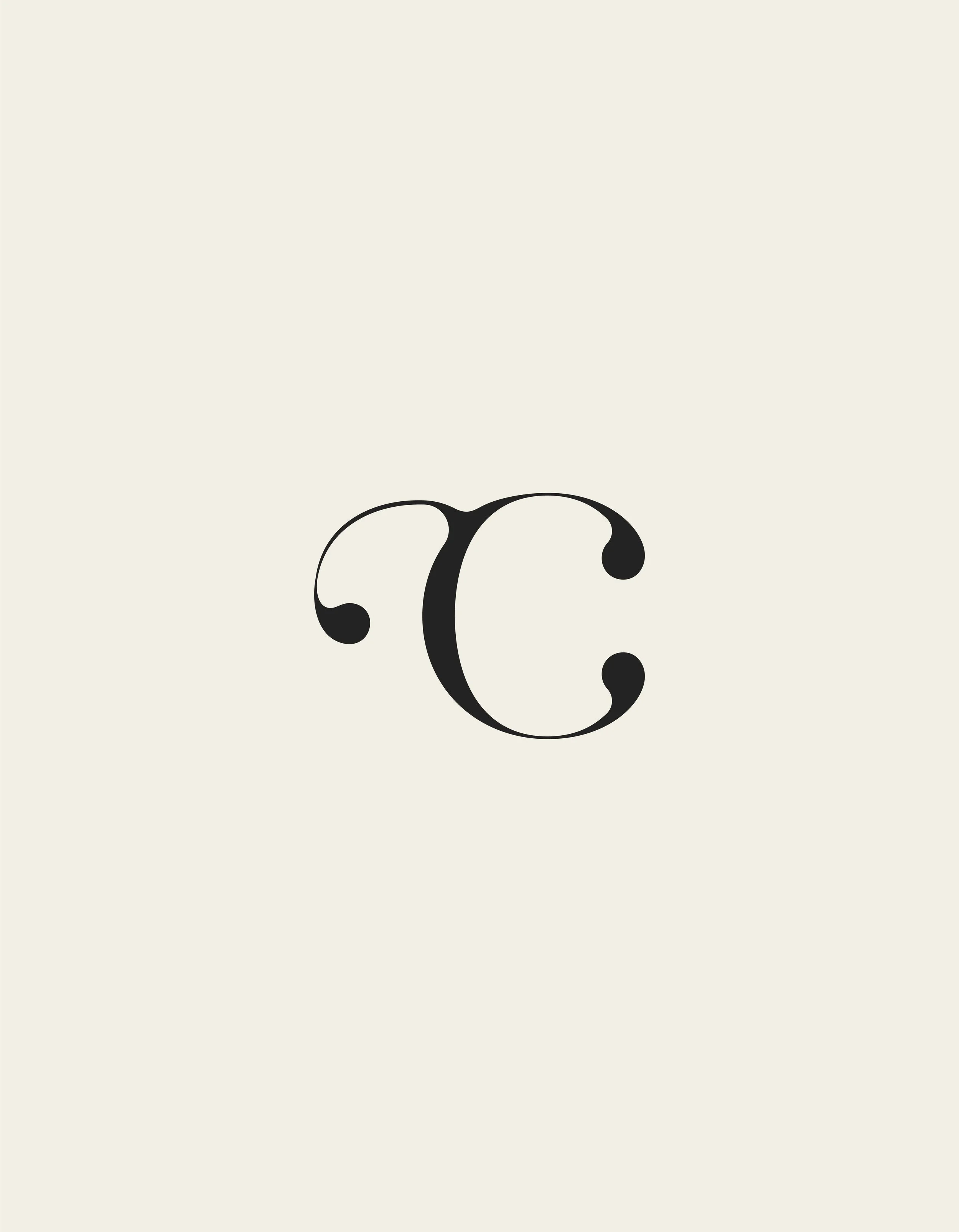 Close-up of black calligraphic letter 'C' on light beige background.