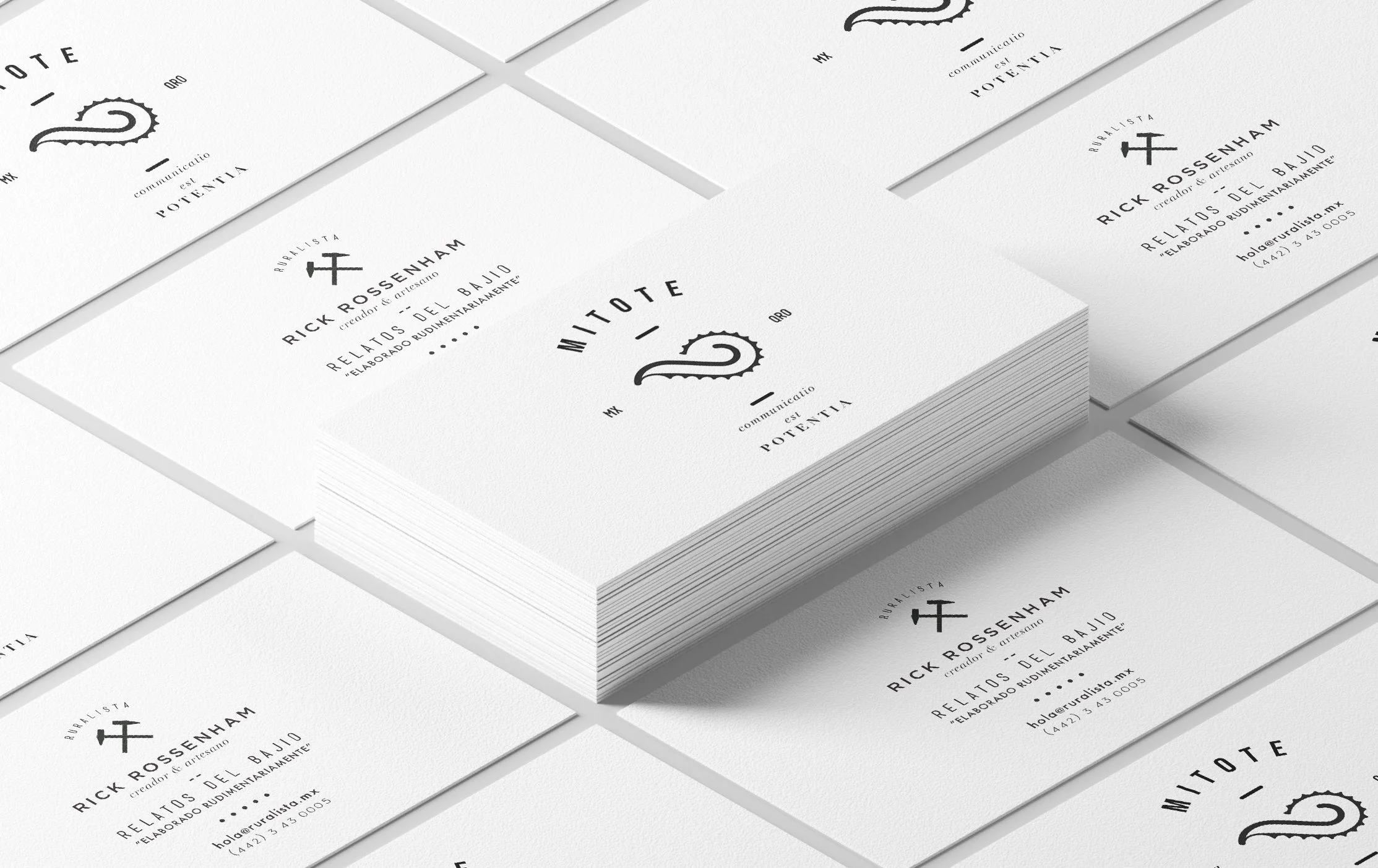 A stack of white business cards with black printed text and logos, arranged on a white surface.