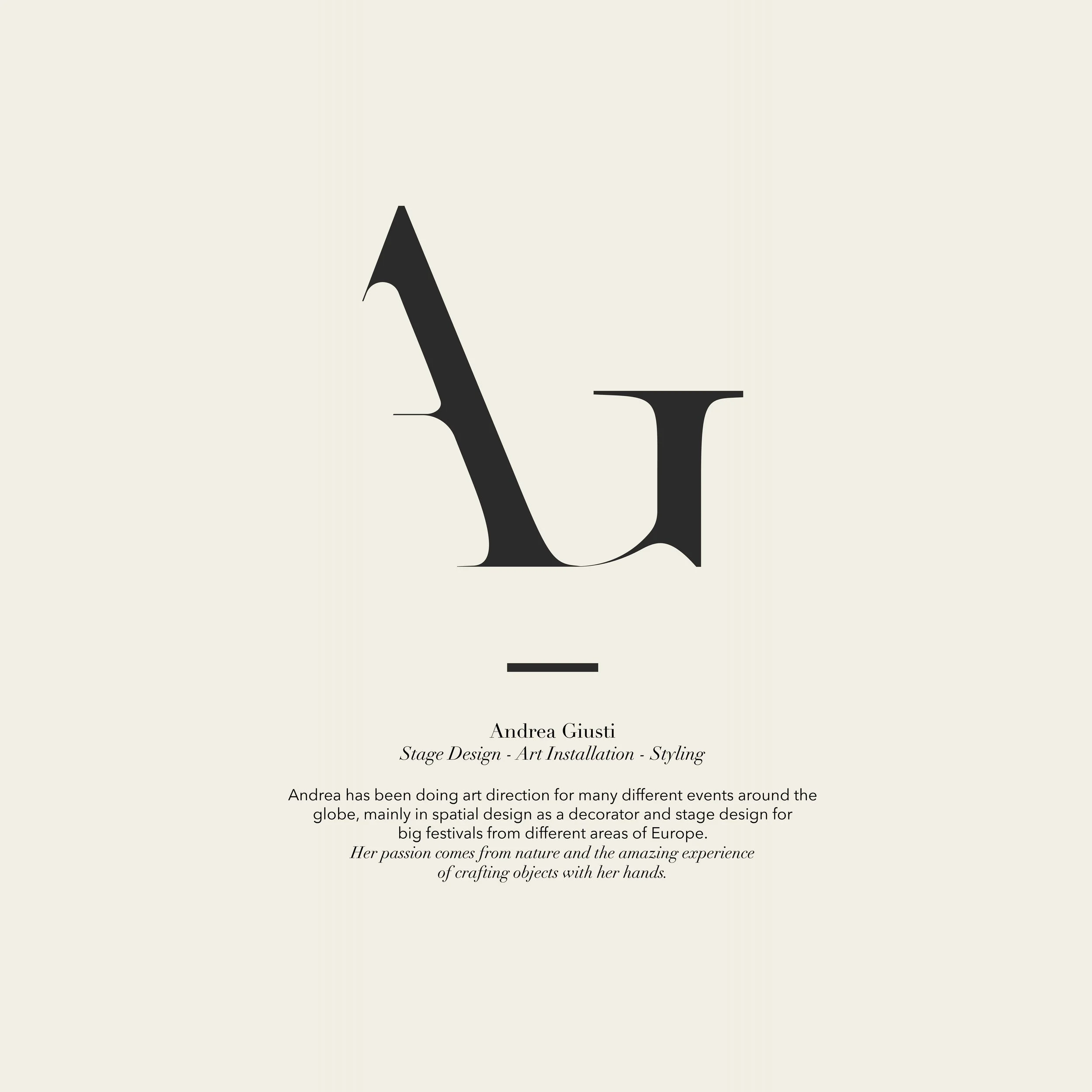 Close-up of a printed page with text about an artist named Andrea Giusti, mentioning her work in stage design, art installation, and styling, with part of a black letter 'A' visible.