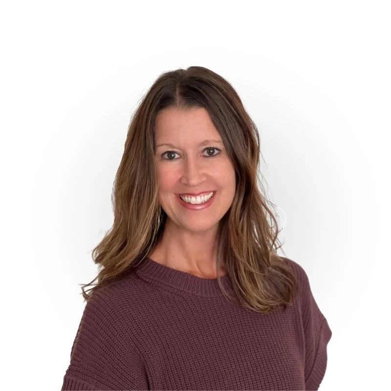 A woman with shoulder-length brown hair smiling at the camera, wearing a maroon sweater against a plain white background.