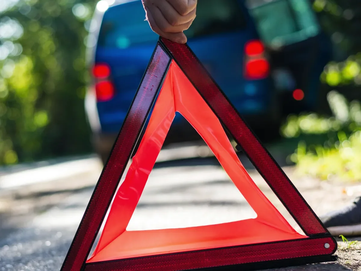 Warning triangle set out on the shoulder of a highway