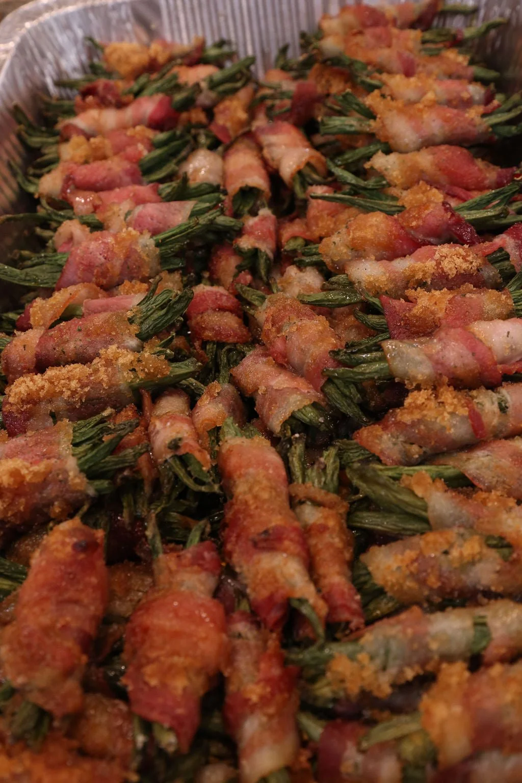 Bacon-wrapped green beans topped with breadcrumbs and baked.
