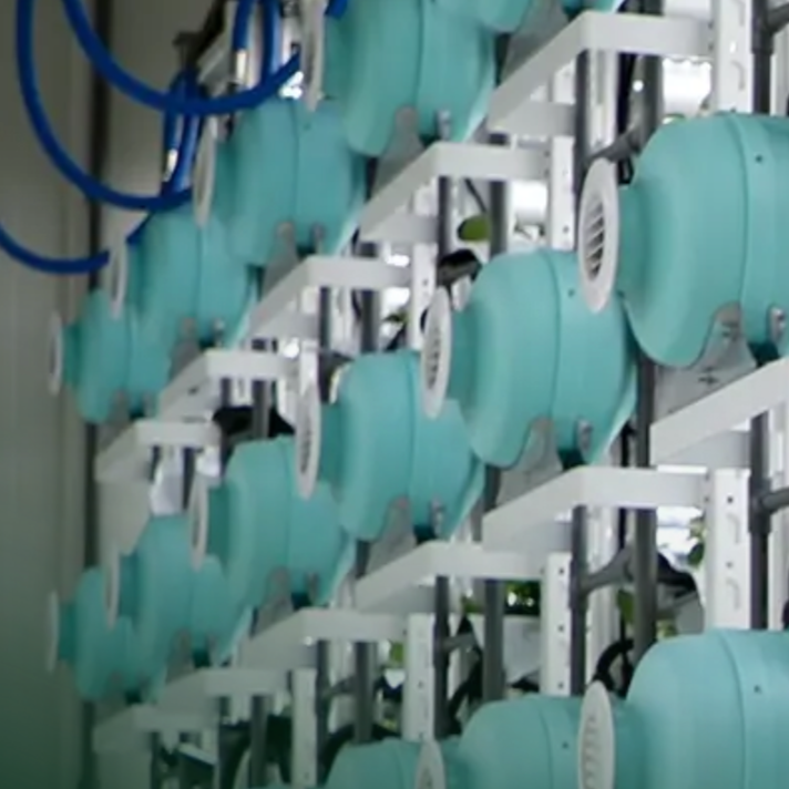 Multiple medical ventilators or anesthesia machines lined up in a medical setting.