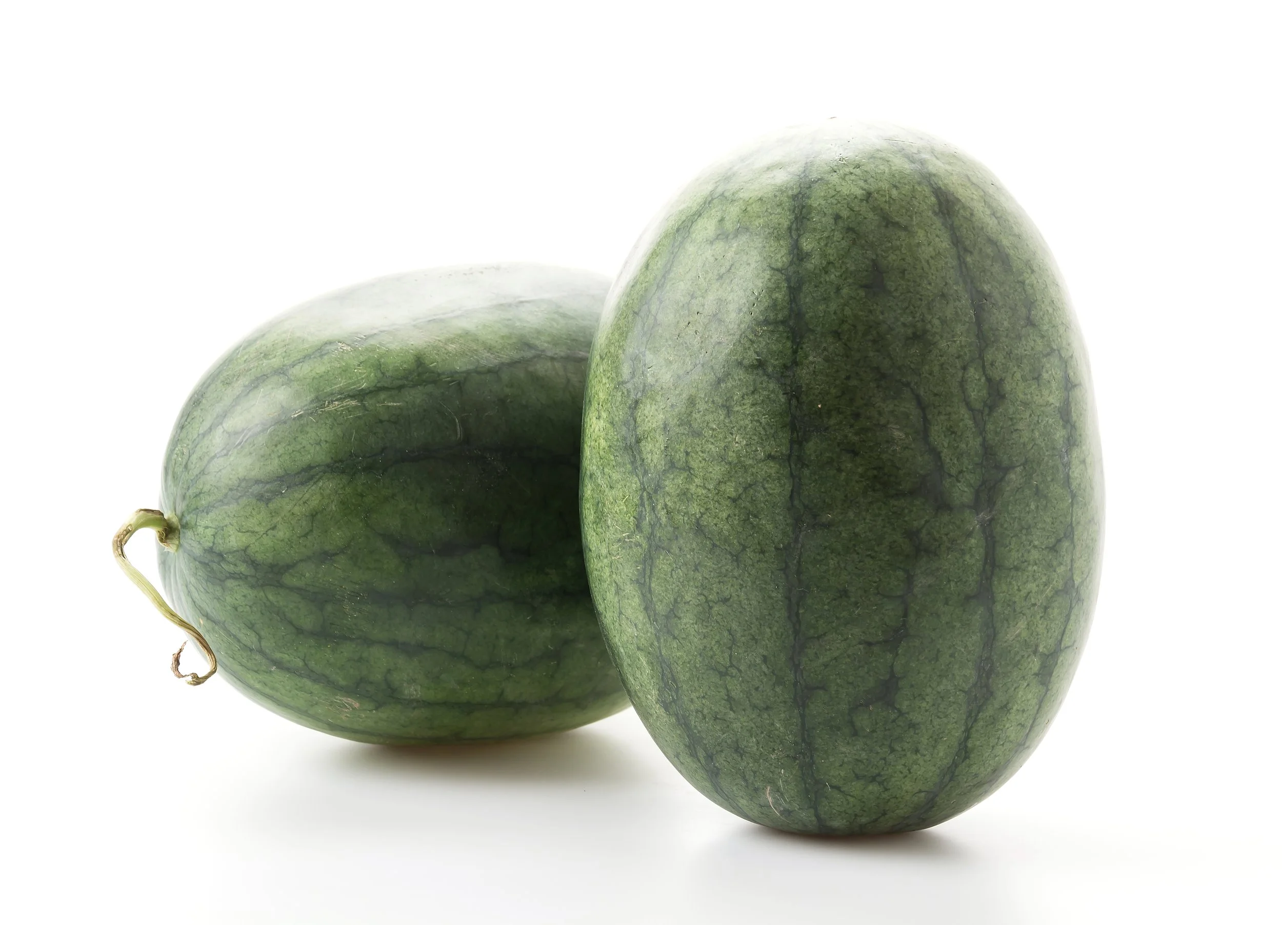 Two watermelons, one whole and one sliced in half, on a white background.