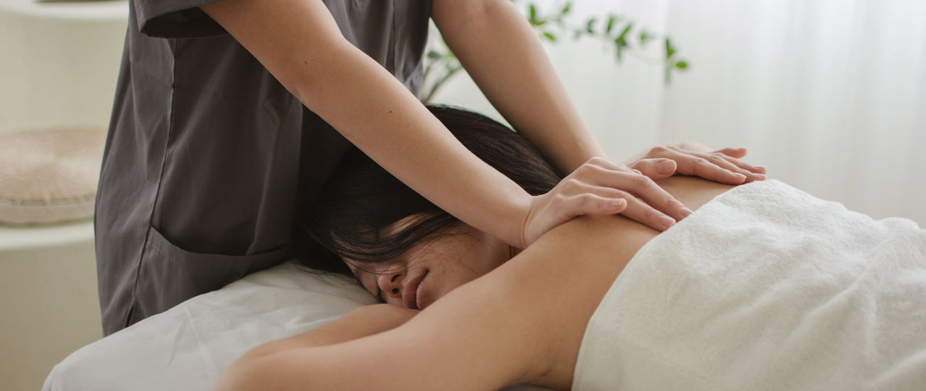 Massage therapist providing relaxing back and shoulder massage in a calm, professional setting