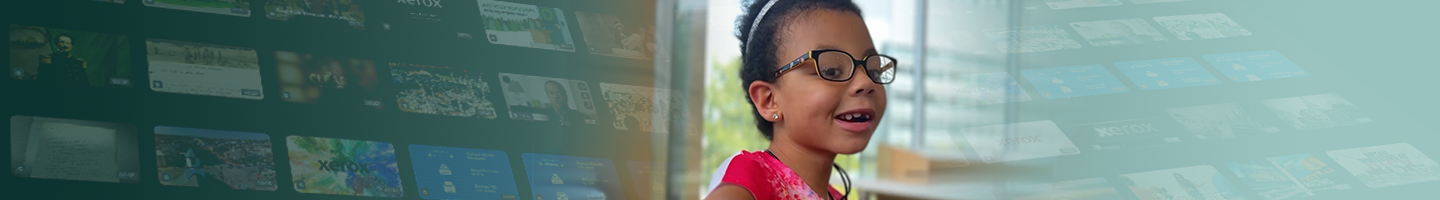 A young girl with glasses smiling at a touchscreen exhibit in a museum.