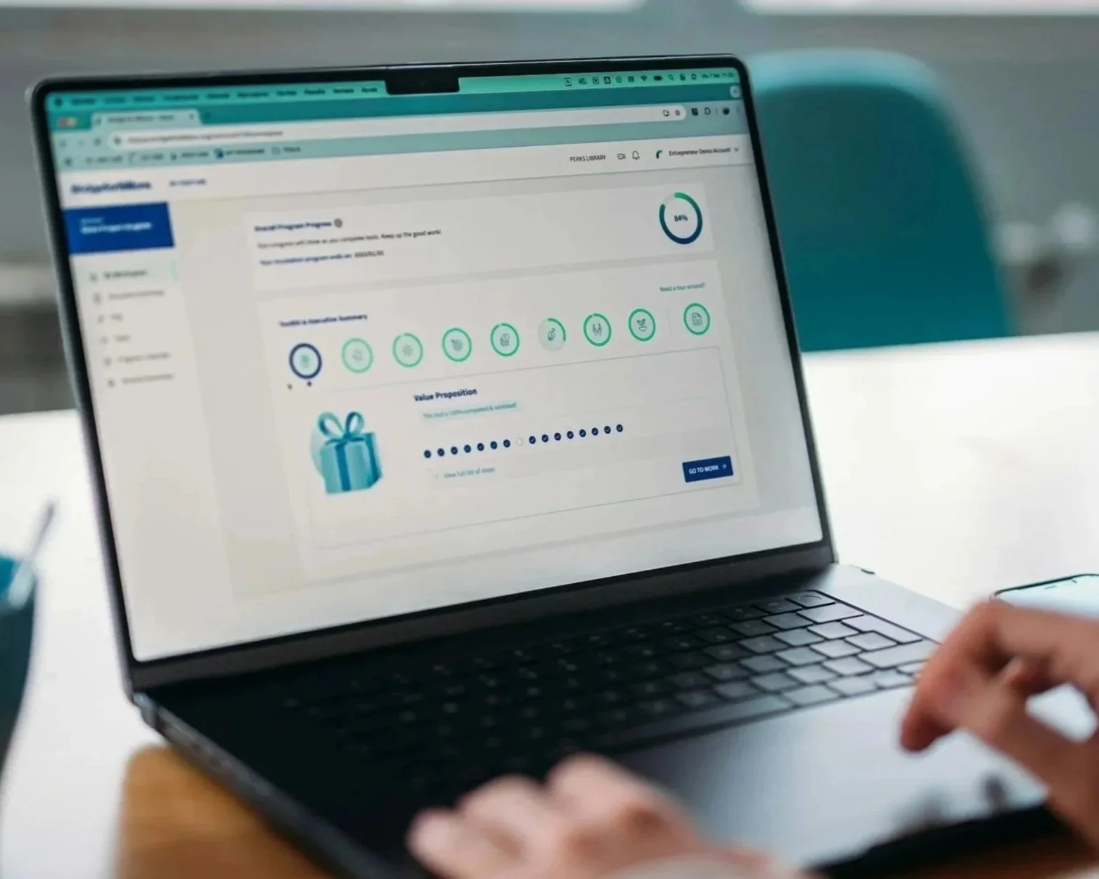 Laptop screen displaying an online survey or review form with progress circle, icons, and a gift illustration.