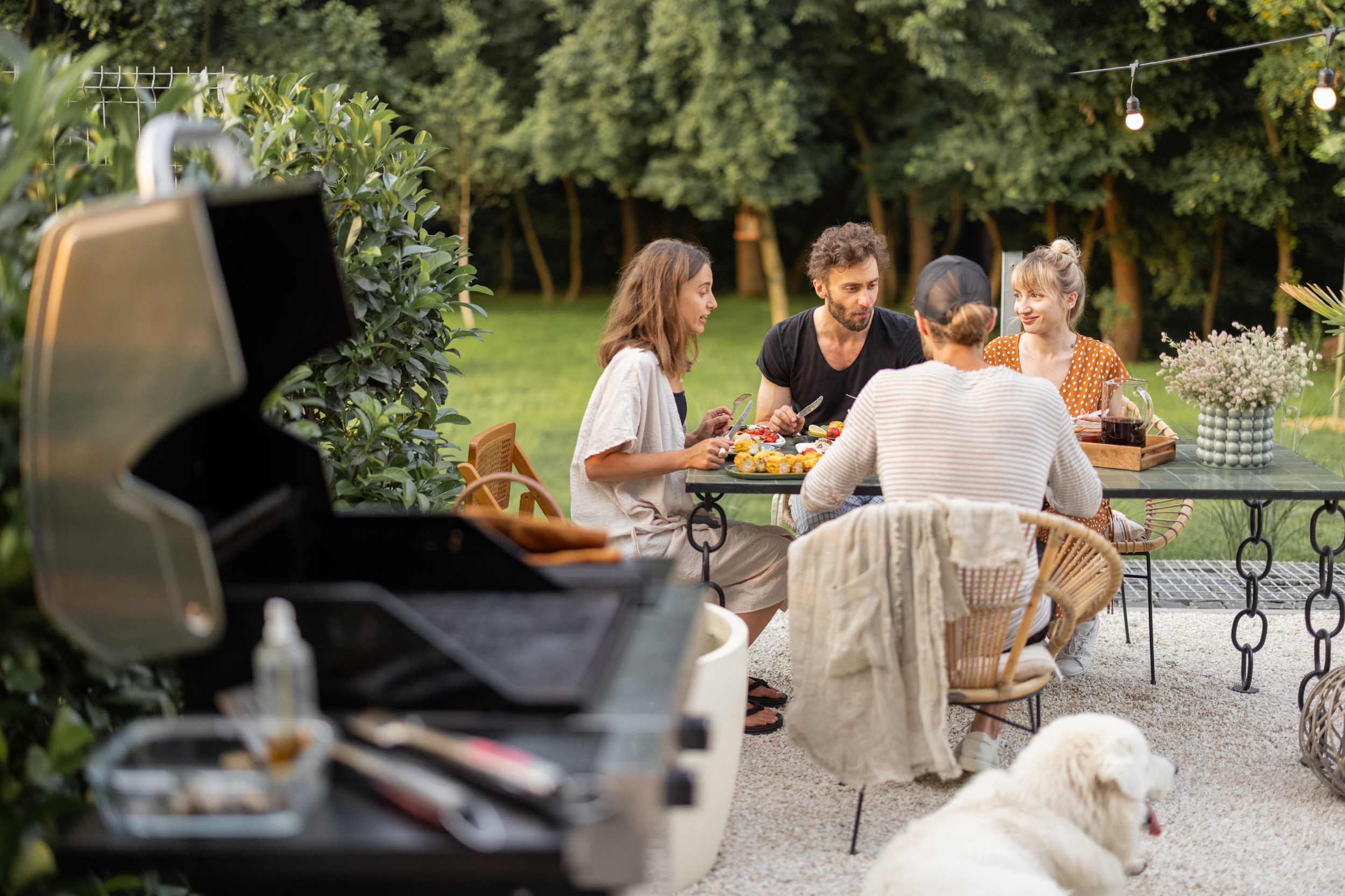 Family enjoying an outdoor meal protected by Bug Brothers mosquito spatial repellent