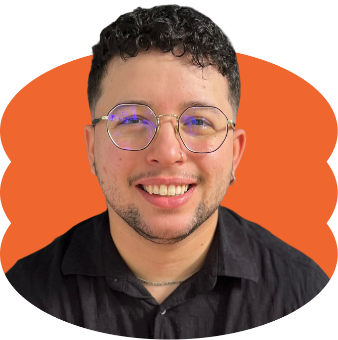 Alex Sastre-Rivera with short curly dark hair, glasses, a nose ring, and a black button-up shirt smiling, placed over a scalloped orange oval shape.