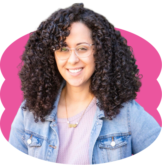 Bárbara López-González smiling, with long curly hair, glasses, and a pink shirt under a jean jacket, placed over a scalloped hot pink oval shape.